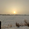 Aachen - Pascalstrasse - sunrise behind a fog bank over a winter landscape