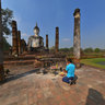 Praying to Buddha in ancient Sukhothai Ruins, Wat Mahathat Thailand