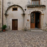 The Court of S. Maria of the Virgins and stone portal and a door in carved wood