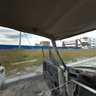 Abandoned car in the area of new buildings