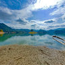 Small island over the lake and a small blue floating house