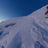 Near Top Of Baldy Sheltered Against The Wind With Photographer
